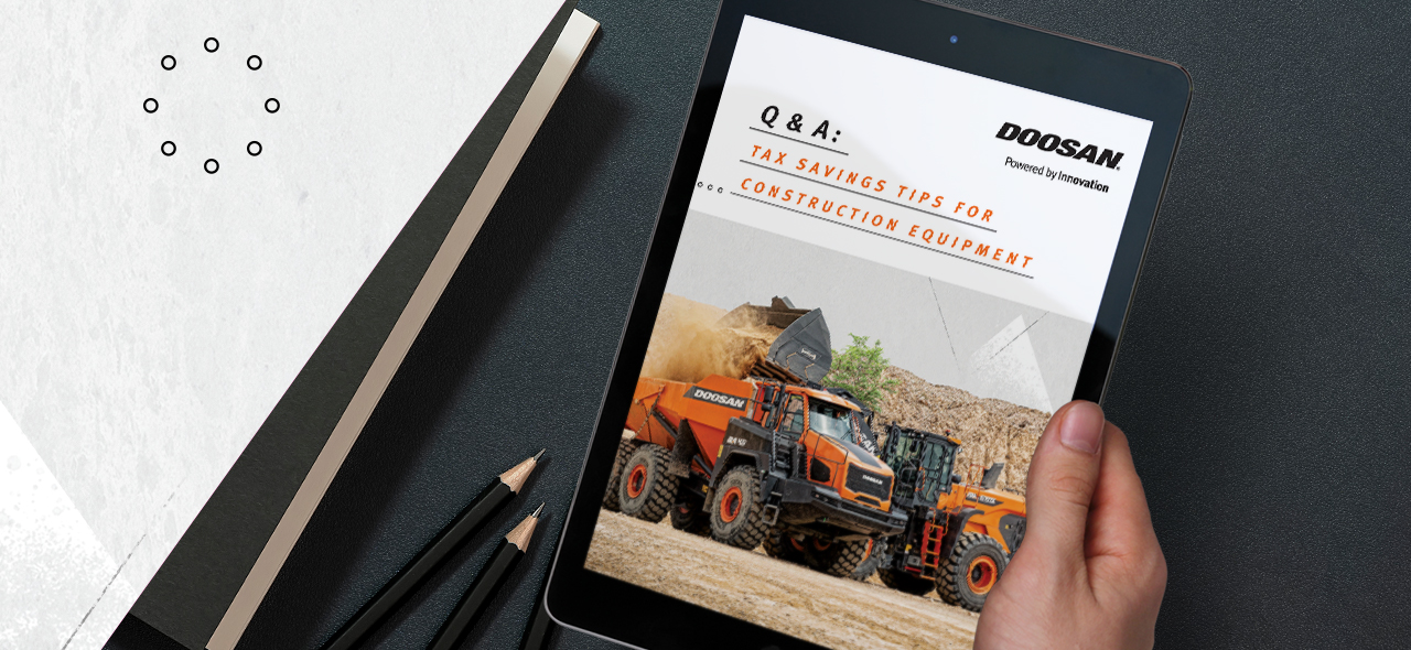 Hand holding a tablet featuring a tax savings for construction equipment white paper.