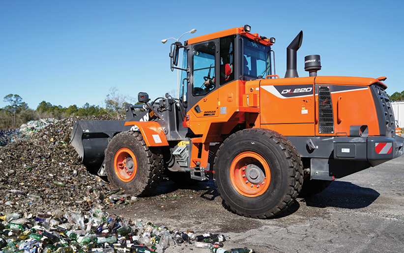 A Doosan DL220-5 wheel loader stockpiles post-consumer glass with a bucket at GlassWRX in Beaufort, South Carolina.